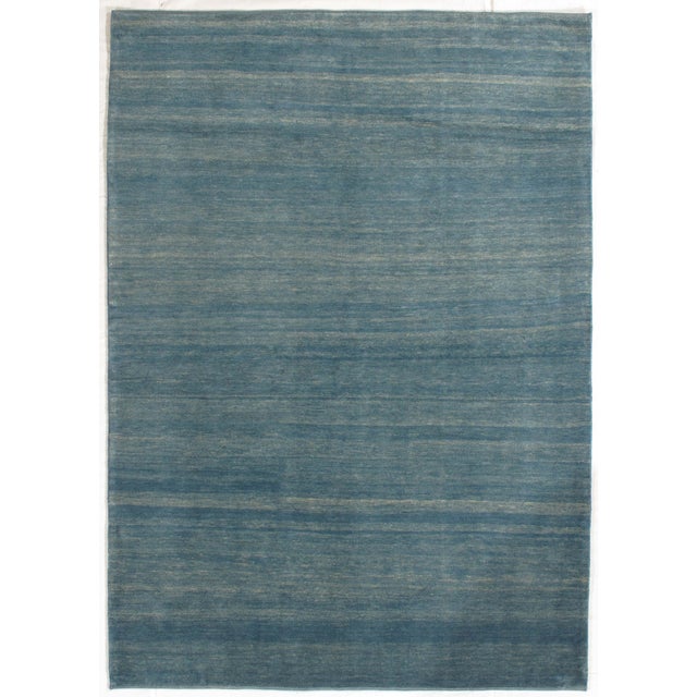 Vintage hand-knotted Persian Lori Gabbeh rug featuring a soft blue field with subtle tonal variation and horizontal...
