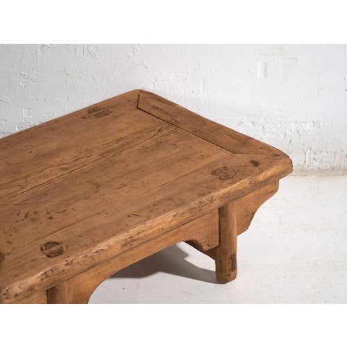 This antique Chinese kang-style low table, crafted in elm wood and dating to around 1900, belongs to the tradition of...