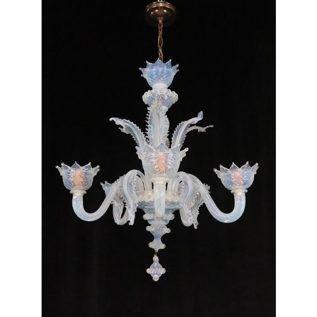 Vintage Murano style chandelier made of opalescent white glass with a cluster of leaves and stemmed flowers that bloom...