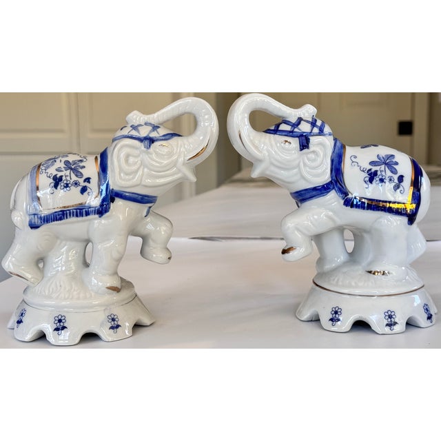 Trunks up for good luck, left foot raised in motion, here is a pair of blue and white chinoiserie auspicious elephants....
