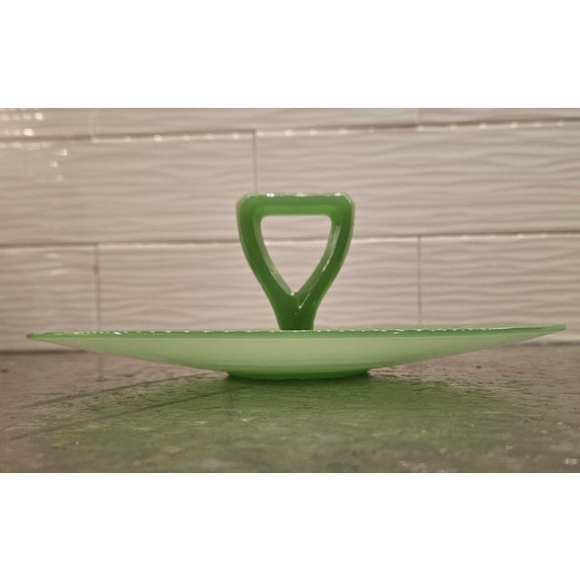This 1950's Art Deco-style Jadeite Glass Tid-Bit Server, measures 11"wide and 4.5" high, was made by the Northwood Glass...