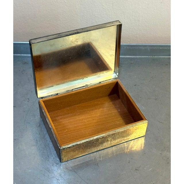 1950s-60s silver metal hinge-top jewelry box w/ wood lining and inner mirror. Excellent condition.