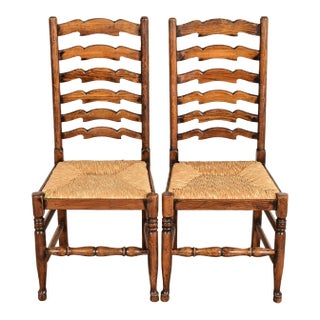 Baker Furniture Style English Country Rustic Carved Solid Oak Ladder Back Dining Chairs With Rush Seats, Pair For Sale
