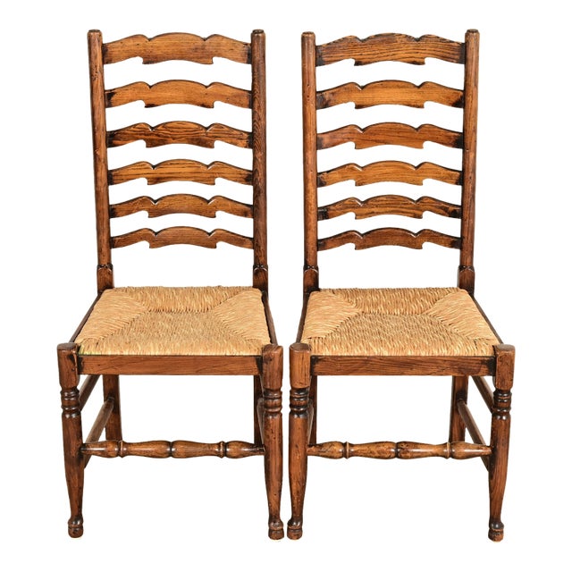 Baker Furniture Style English Country Rustic Carved Solid Oak Ladder Back Dining Chairs With Rush Seats, Pair For Sale