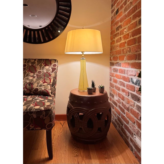 Vintage Italian Murano glass table lamp featuring a hand-blown ribbed form in a warm yellow tone. The elongated silhouette...