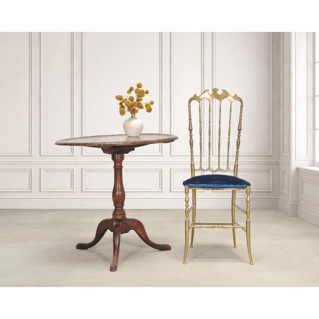 A charming 19th century English Georgian dessert, side, or occasional table constructed with a tripod base and a tilt-top...
