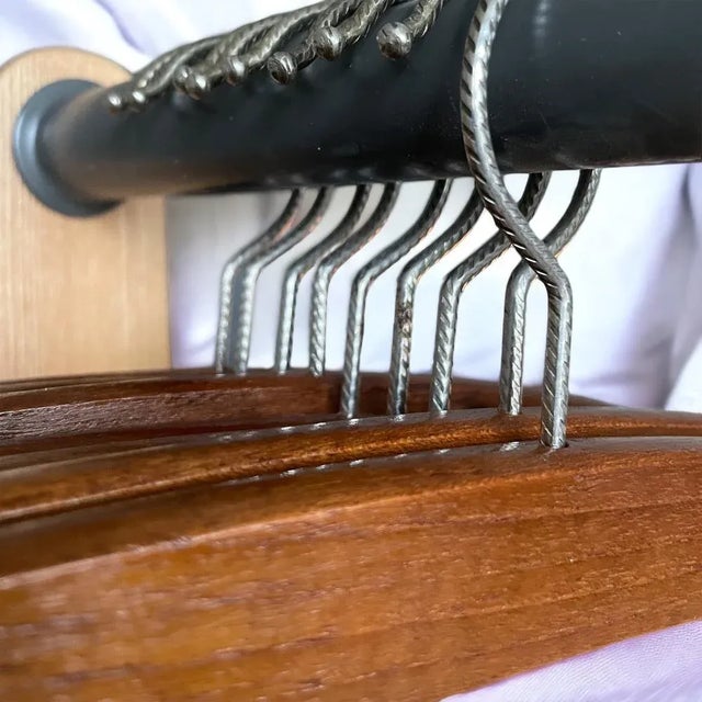 A stunning collection of 9 exquisitely crafted teak wood coat hangers from 1960s Denmark, radiating timeless beauty and...