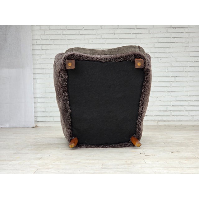 1960s, Danish design. Completely renovated-reupholstered armchair. Reupholstered in quality genuine sheepskin from New...