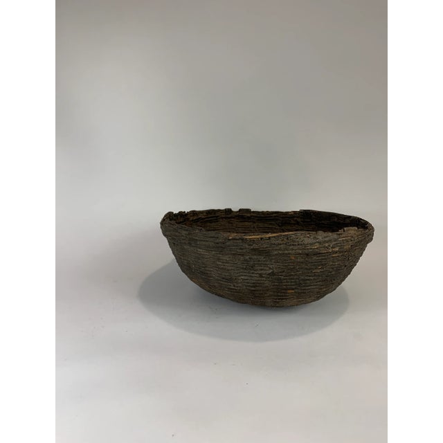 Handcrafted rattan basket from India. Further strengthening with clay/earth.