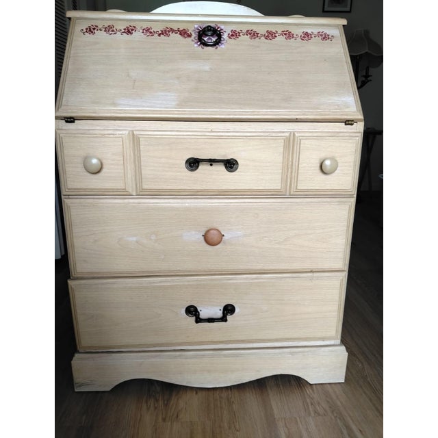 This desk is a heirloom; crafted from solid wood, it features hardware that allows the tabletop to be opened. Its three...