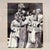 This is a framed vintage photograph capturing a group of performers in ornate, traditional costumes, highly characteristic...