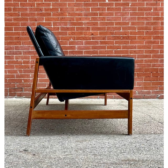 A Danish teak three seat sofa in original soft leather upholstery and the style of , Svend Aage Eriksen for Glostrup...