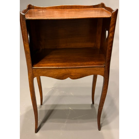 French Louis XV style walnut commode side table featuring elegant cabriole legs and finely hand-carved decorative heart...