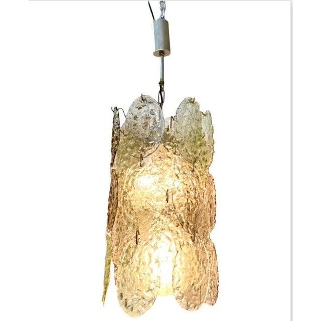 A stunning pair of 1960s glass disk chandeliers made in Murano, Italy. Designed by well known Italian designer Gino...