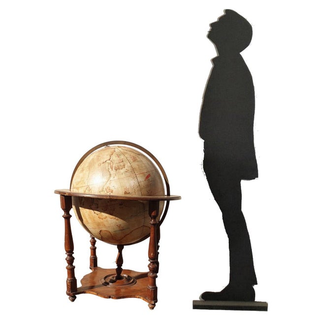 Large terrestrial globe in papier maché and plaster, fixed in its wooden basket: the spindles are painted with the...