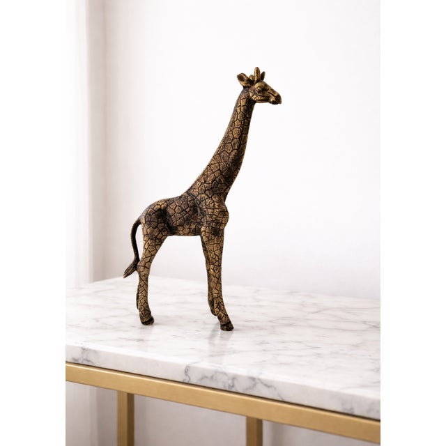 Enhance your home décor with this elegant antique-style giraffe sculpture, beautifully crafted from real metal and...