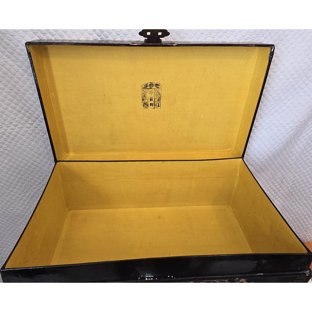 Rectangular Chinese black lacquer storage box with gilt and polychrome decoration, raised on a fitted wooden stand. The...