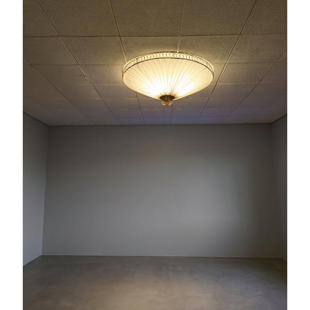 The ceiling lamp was designed by Paavo Tynell and manufactured by Idman in Finland in the 1950s. This lamp can be found in...