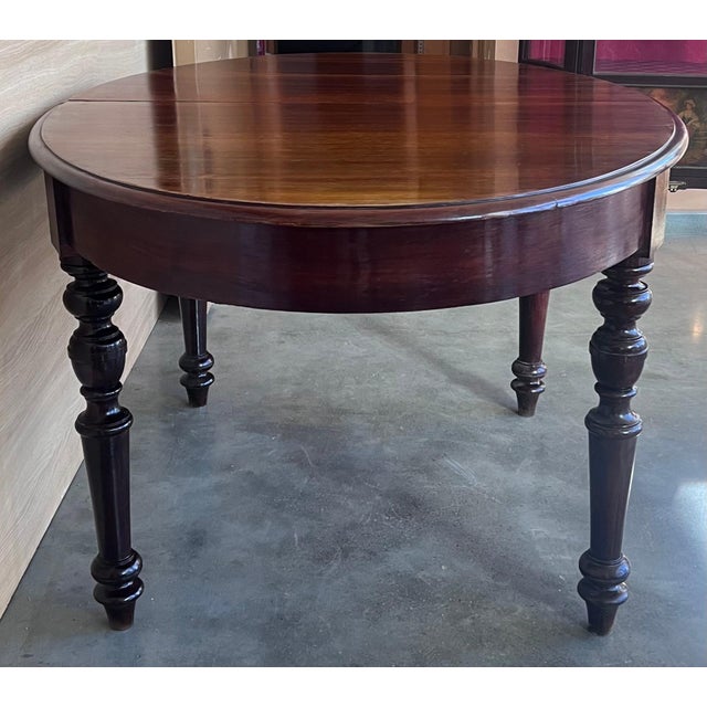 An antique Spanish Carved Walnut Four Legs dining table. Circa 1900. Having a round top over a beaded skirt, rising on a...