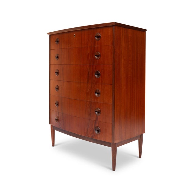 A masterful example of Danish Mid-Century Modern design, this 1960s teak tallboy dresser embodies the harmony of form,...