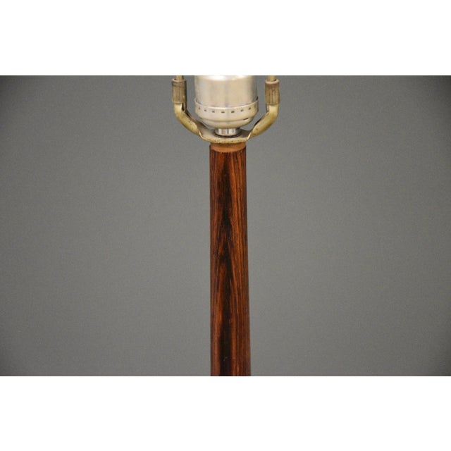 A mid century modern rosewood floor lamp. Circa 1960’s. Made in Sweden. 54.25” to top of harp. 9.5” diameter. 47.25” tall...