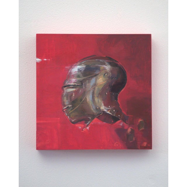 This artwork features a striking depiction of a metallic helmet, rendered in rich oil paint against a vibrant red...