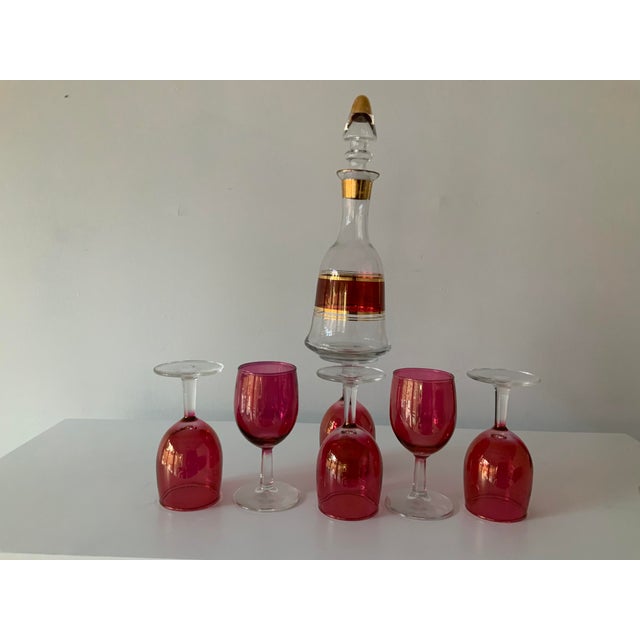 Set of 6 cranberry vintage glasses with matching cranberry and gold vintage decanter. Make your bar or bar cart the toast...
