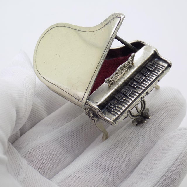 An elegant and playful vintage sculpture depicting a grand piano, handmade in Italy between the 1980s and 1990s in genuine...