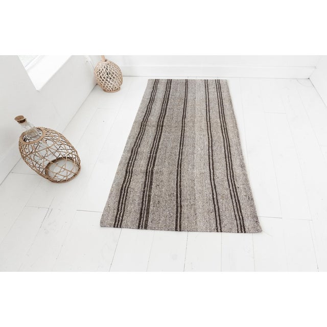 This is a vintage Turkish Oushak rug from the Mid 20th Century. The piece was hand-knotted.