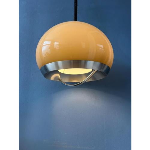 Beautiful space age pendant by Dijkstra in beige/mocca colour and aluminium/metal frame. The shade produces a magnificent...
