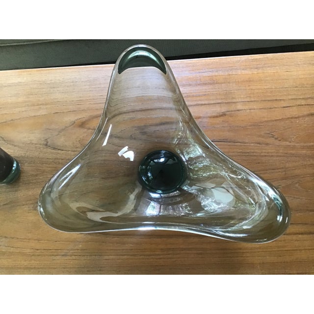 The bowl and vase have a simple, yet fluid design. The three rounded lobes of the bowl resemble waves. The bowl is...