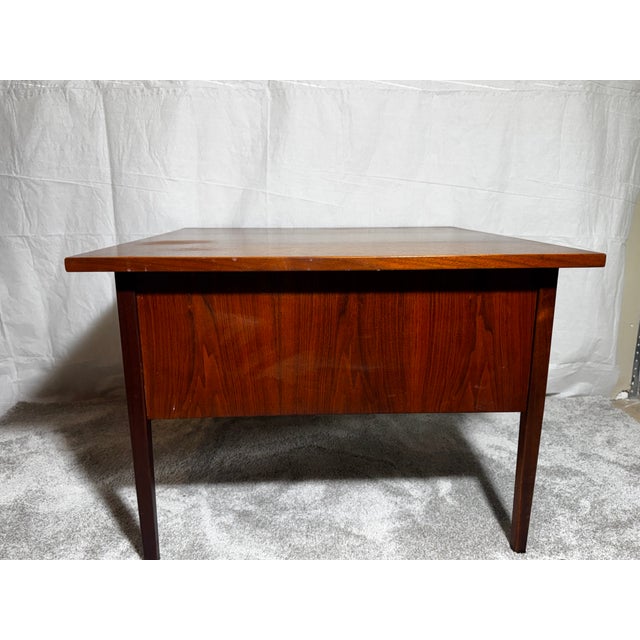 3-drawer side table in a rich, dark walnut finish. Has three dovetailed drawers with sculptured walnut pulls. They are...
