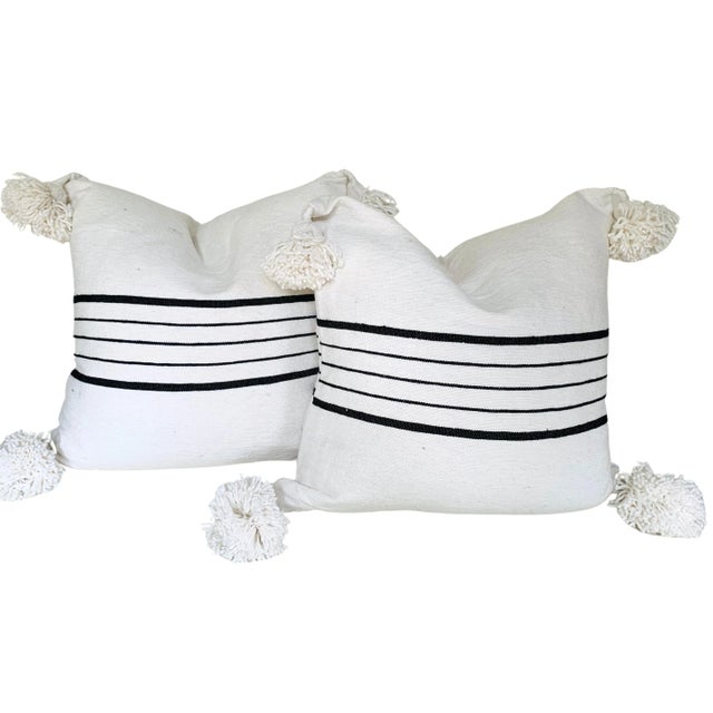 Pair of Moroccan handloomed cotton pom pom pillows with zipper closure New duck feather-and-down fill inserts. Pattern on...