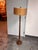 Design Plus Gallery presents a Contemporary Wood + Metal Floor Lamp. A wood frame pairs with a metal base for a...