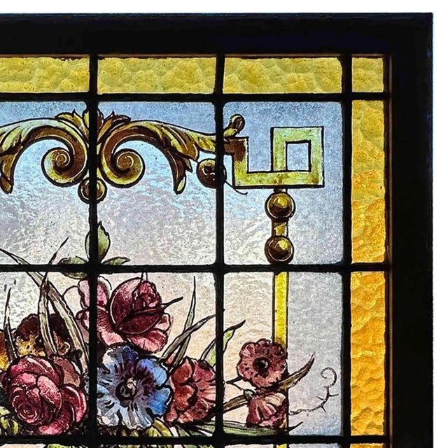 Antique, late 19th century German stained glass panel. This lovely work features an amber stained glass border surrounding...