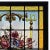 Antique, late 19th century German stained glass panel. This lovely work features an amber stained glass border surrounding...