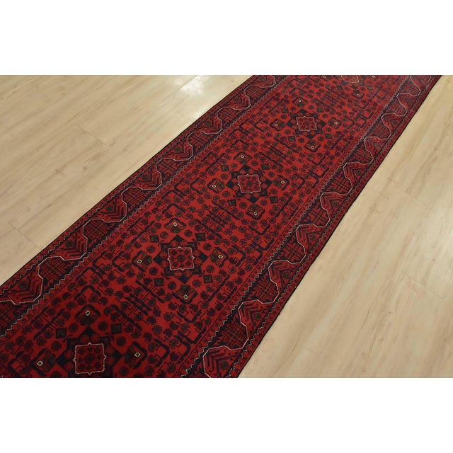 An authentic tribal Turkmen rug hand-knotted with fine wool and natural dyes. This nomadic rug features a row of geometric...