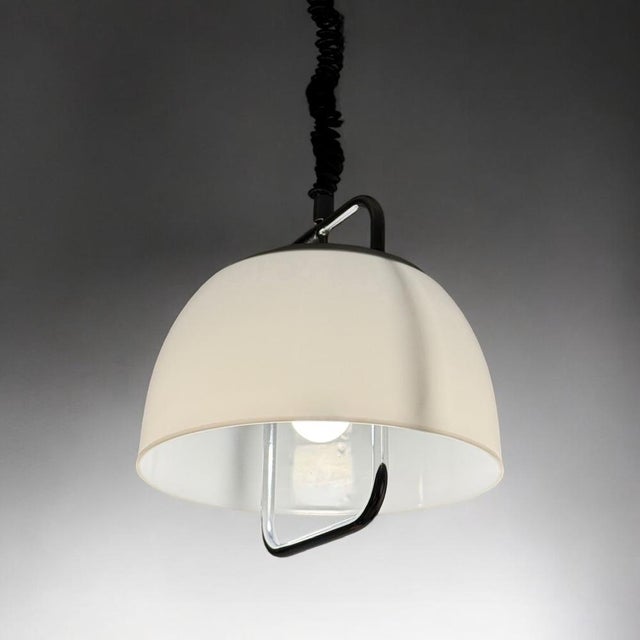 This harvey guzzini 70s pendant lamp embodies the refinement of italian lighting design. Its white methacrylate shade...