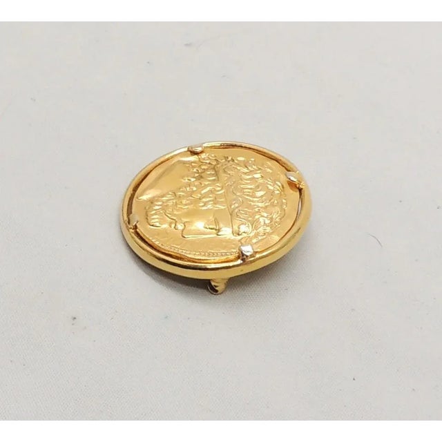 This is part of Chairish’s Costume Jewelry assortment. Goldtone round inset "coin" Greek head with the name Dionysus...