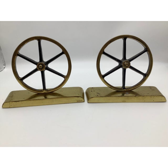 A cool set of two brass wagon wheel bookends. The bookends were made by Virginia Metal crafters. The bookends were made in...