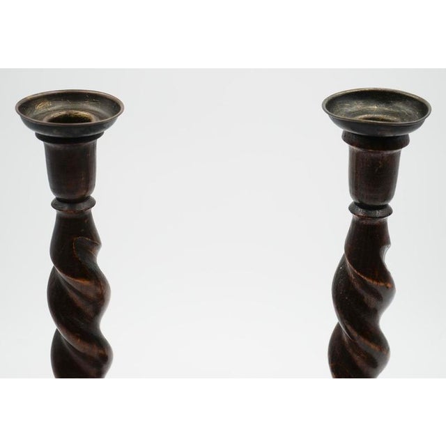 A charming pair of Early Victorian English oak barley twist candlesticks, beautifully turned with classic spiral stems and...