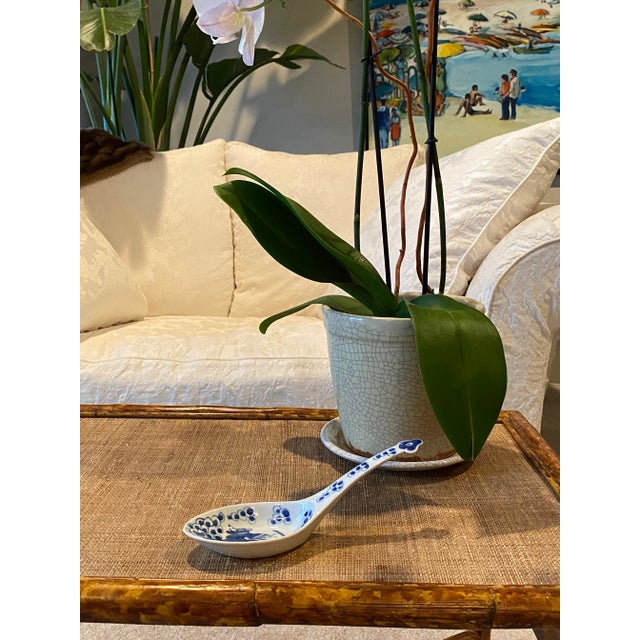 Hand painted Blue and White Chinoiserie spoon rest. Asian figure in the center of the piece. Beautiful as a functional...