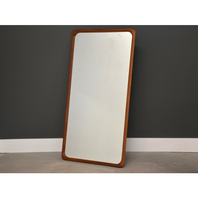 A mid century teak mirror. Made in Denmark. Circa 1970’s. Excellent condition. 25.75” wide. 50” tall.
