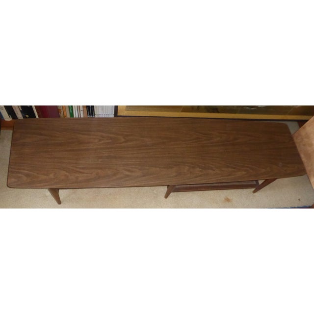 Formica top, ratan shelf and single drawer.