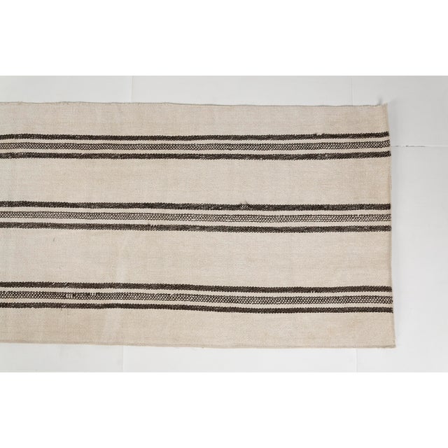 This is a vintage Turkish Oushak rug from the Mid 20th Century. The piece was hand-knotted.