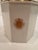 Elegant white and gold diminutive ice bucket with regal crest decoration and gold finial. With handle up, 13” h. Down 12”...