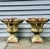 A substantial and highly decorative pair of 19th-century cast iron garden urns with figural masks, large pendant ring...