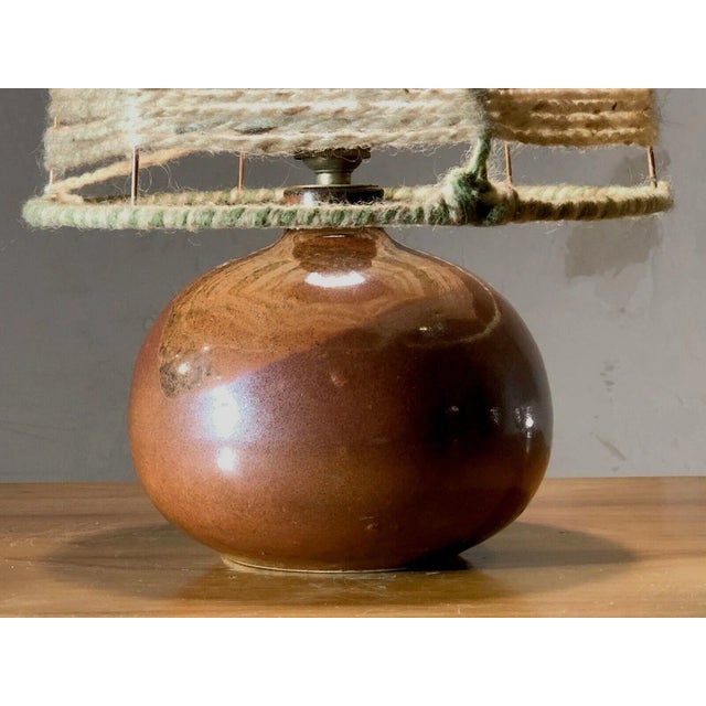 A small modernist table lamp or night light, free form, popular art, shabby-chic, curved body in ocher and brown enameled...