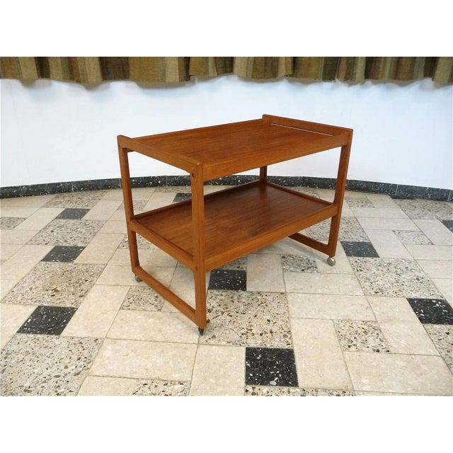 This Danish trolley was made during the 1960s. It is made from solid and veneered teak with a grain.