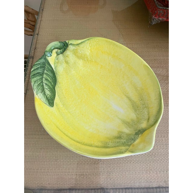 This fun ceramic piece is in the form and painted to look like a giant lemon. From the coast of Italy and stamped on the...